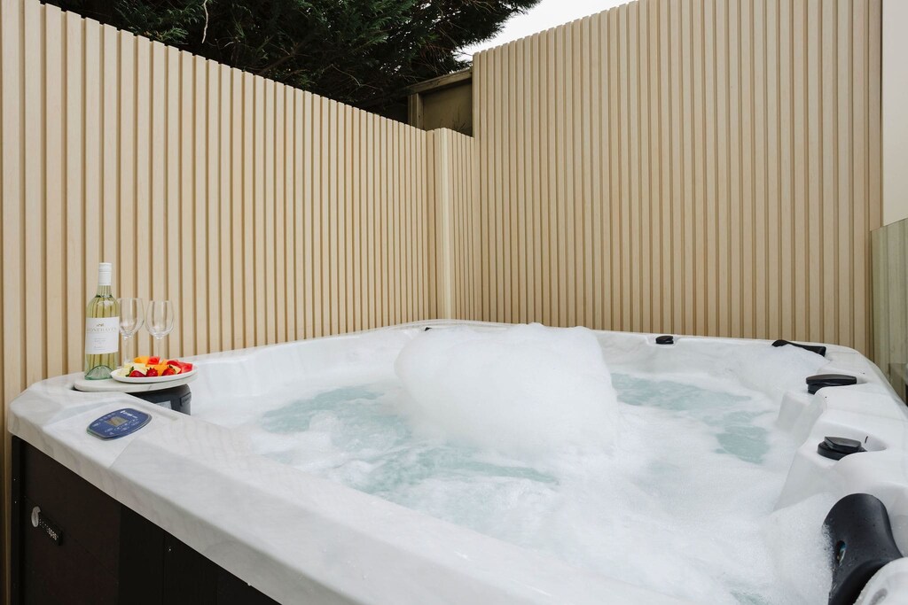 Relax in the private hot tub nestled at the back of the property, perfect for unwinding after a day of exploring.