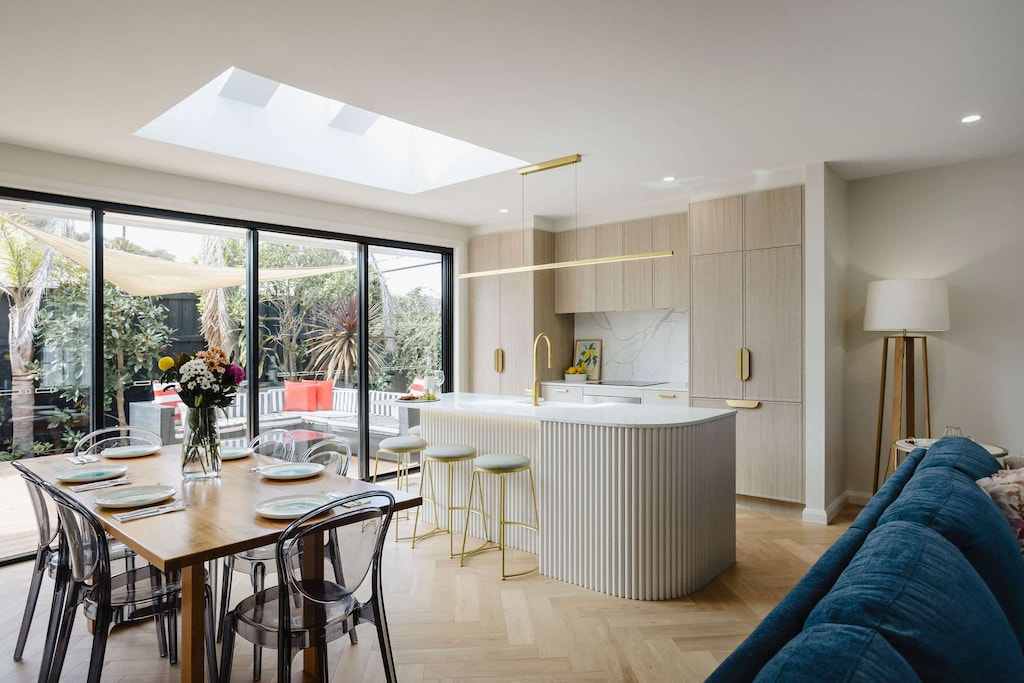 Elegant kitchen counter flowing into a stylish dining space with a bright and inviting view of the kitchen.