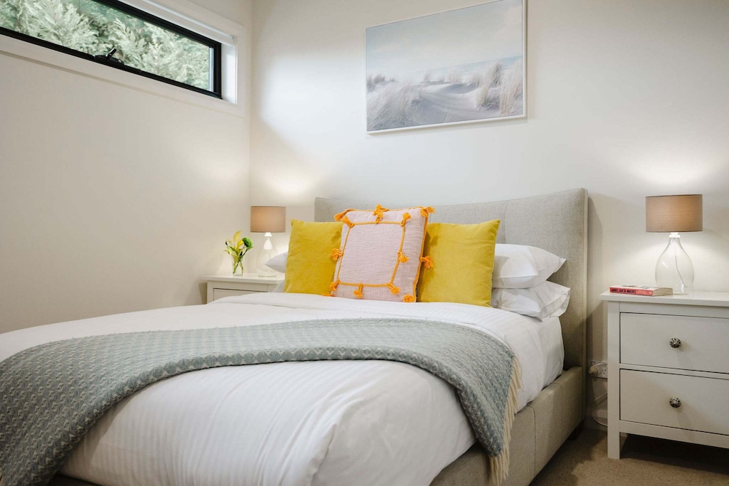 Elegant double bedroom located on the first level, offering a peaceful retreat with tasteful furnishings, soft lighting, and a conveniently situated bathroom just outside the room for added privacy and comfort.