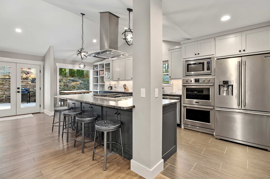 Our bright, open-concept kitchen features a huge island with barstools and high-end appliances.