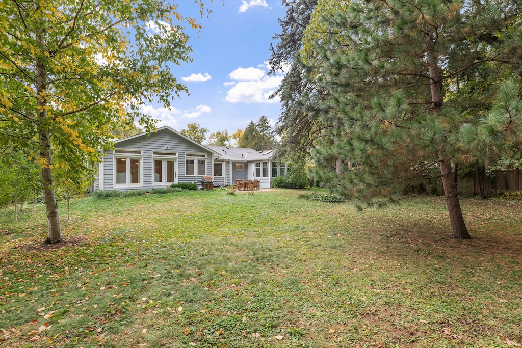 Charming ranch-style property nestled among mature trees with spacious private grounds and peaceful outdoor seating area.