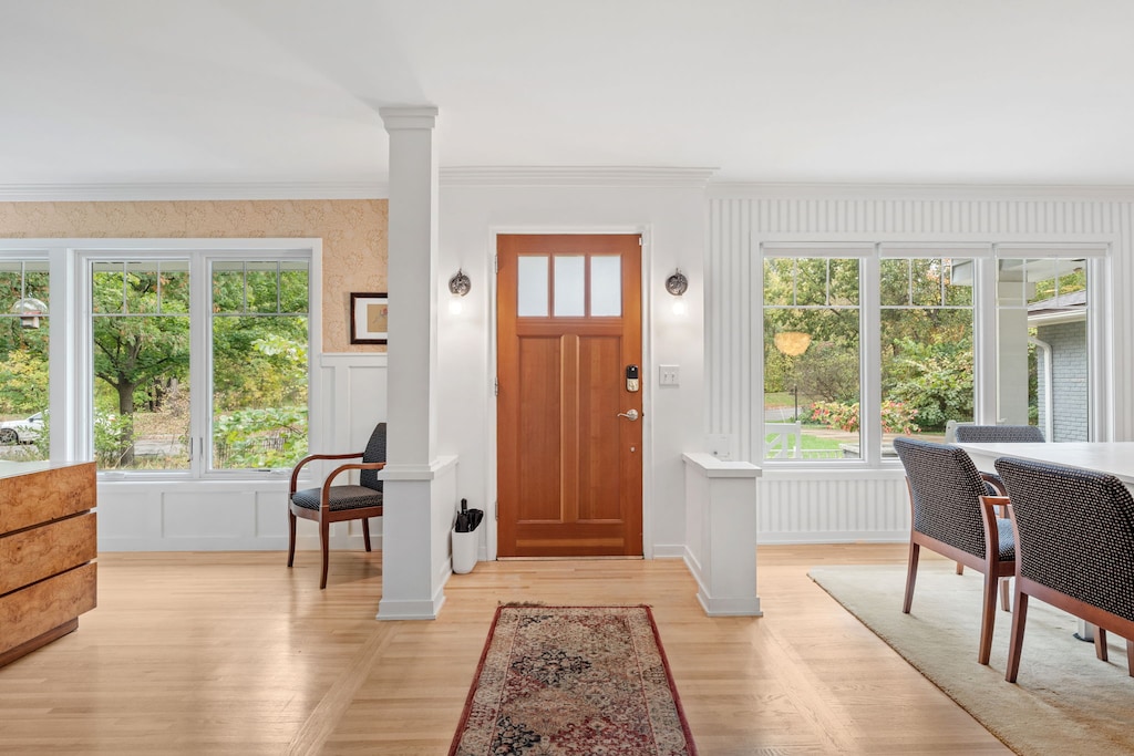 Step into your bright, welcoming entryway with gleaming hardwood floors and abundant natural light streaming through oversized windows.