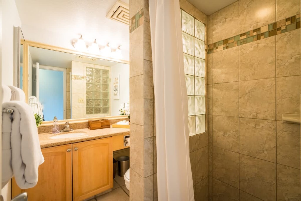 Refresh in our elegant bathroom with a spacious shower and warm, inviting decor.