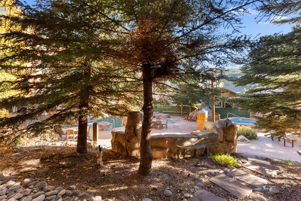 Private patio with outdoor seating near the pool. 