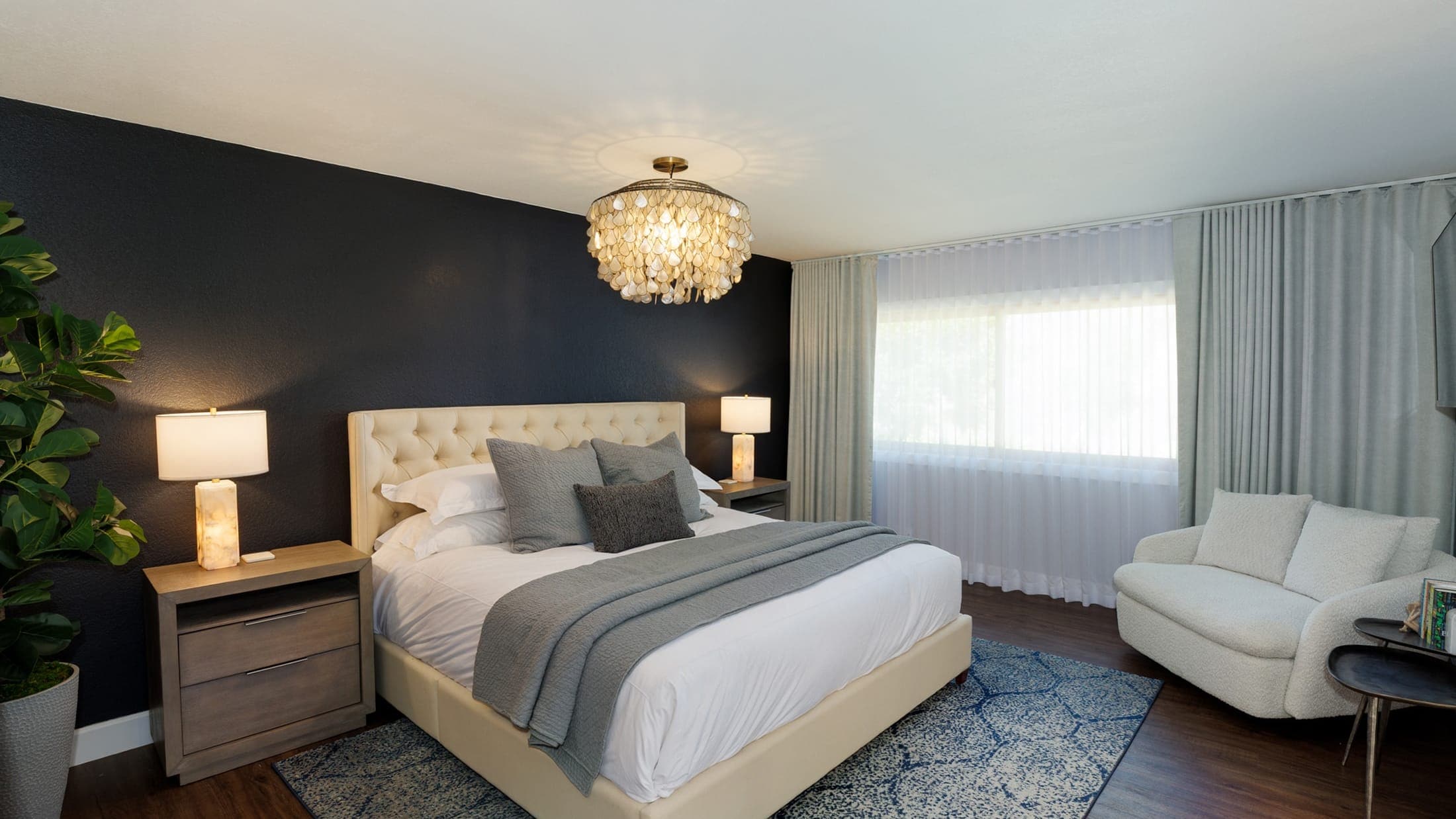 The primary bedroom features a king bed, TV, walk-in closet, and an ensuite bathroom. The primary bedroom features a king bed, TV, walk-in closet, and an ensuite bathroom.