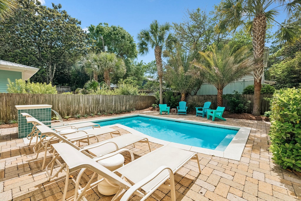 Soak up the sun by your private pool, surrounded by lush palms and vibrant turquoise lounge chairs—perfect for lazy afternoons and tropical relaxation.