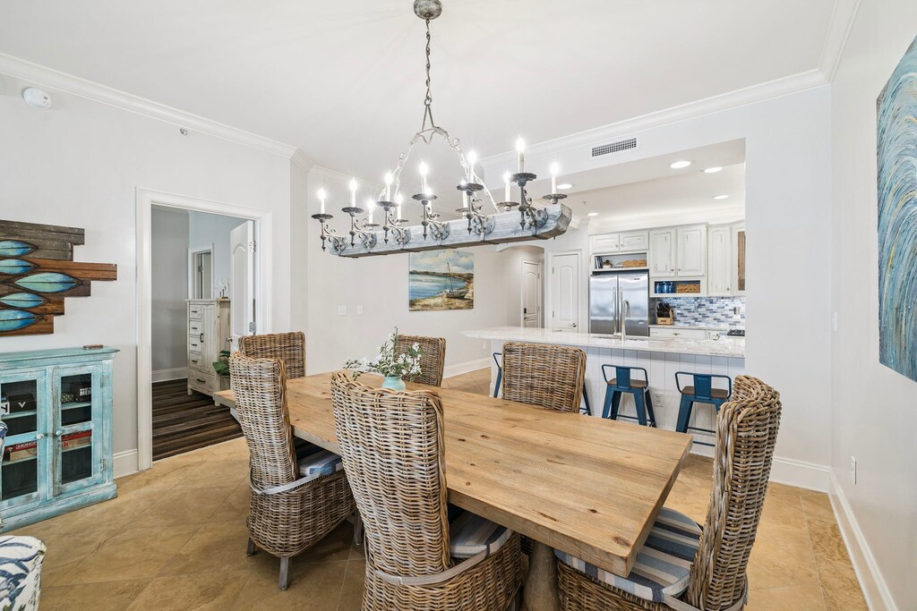 Your open dining space flows into a gourmet kitchen, where coastal charm meets modern convenience for memorable meals together.