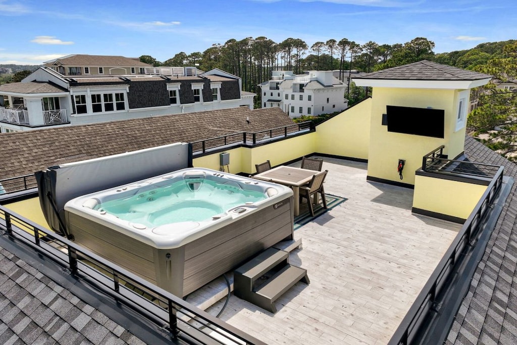 Rooftop hot tub with sitting area and TV