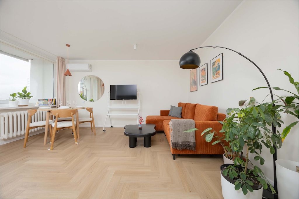 A spacious open-plan living and dining area filled with natural light and elegant furnishings.