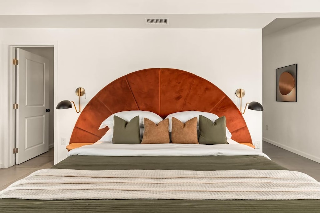 Bedroom 1, king bed and arched headboard