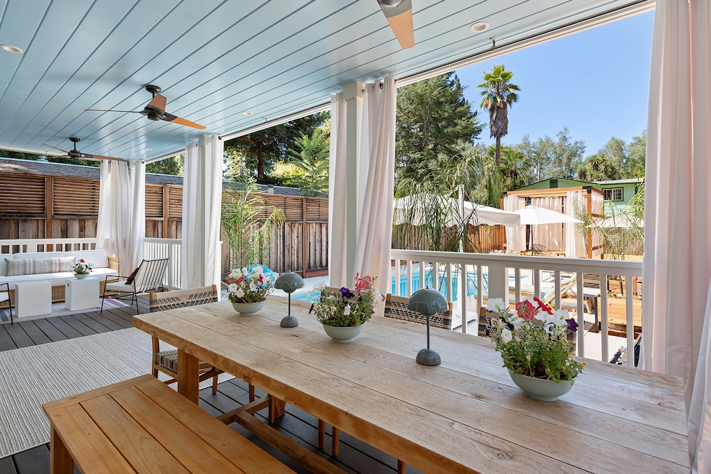 Your sunny, hilltop resort-feel deck and yard complete with a covered veranda