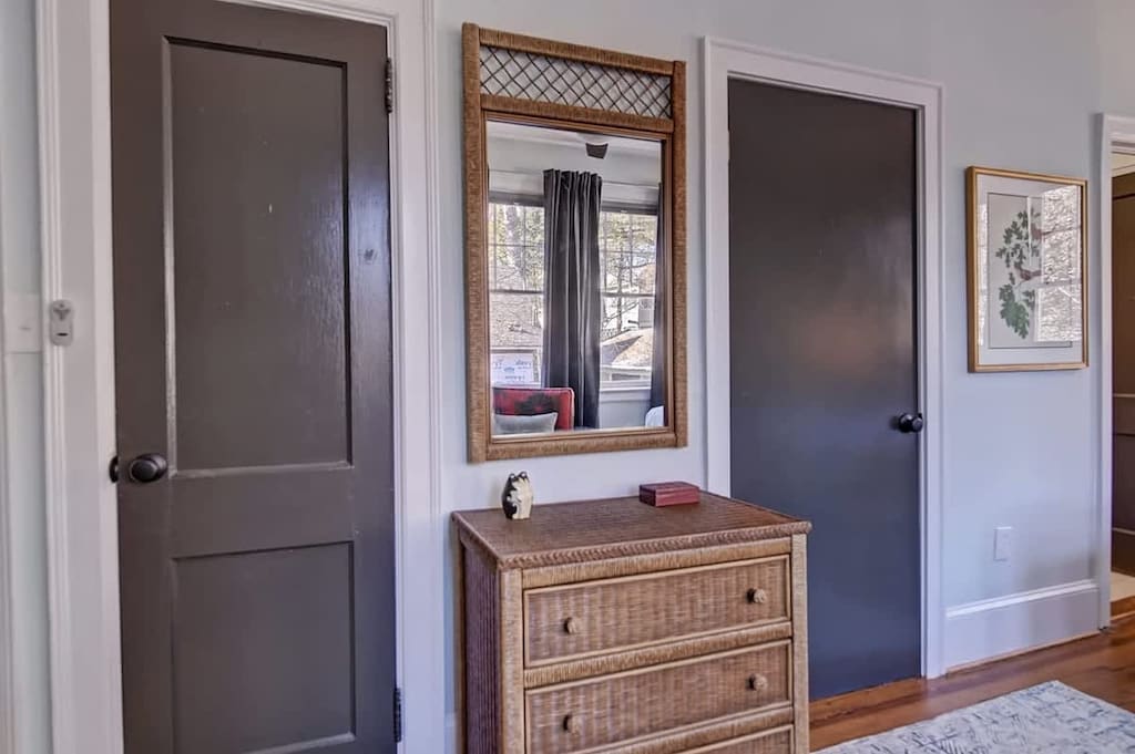 Rattan framed mirror between doors