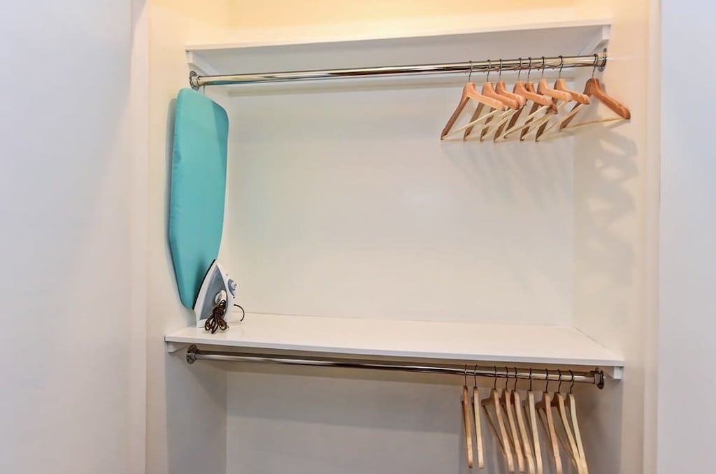 Built-in closet with hangers and ironing materials