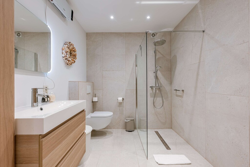 Start your day fresh: walk-in rain shower, sleek design, and fluffy towels waiting for you.