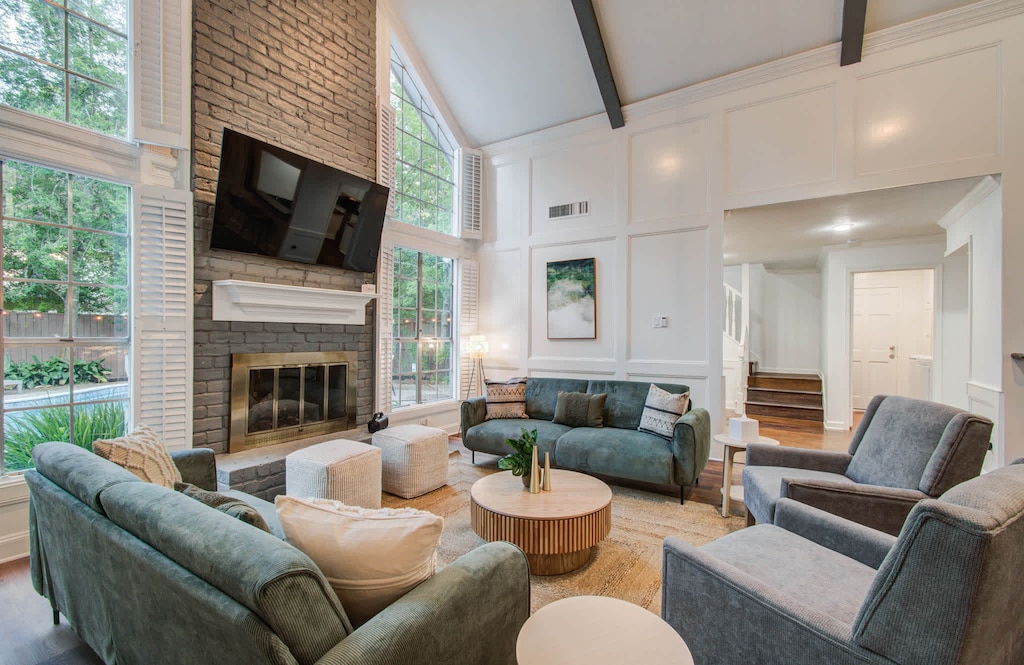 You’ll want to spend plenty of time in this grand and spacious living room, with floor-to-ceiling windows, plenty of comfortable seating, and airy vaulted ceilings!