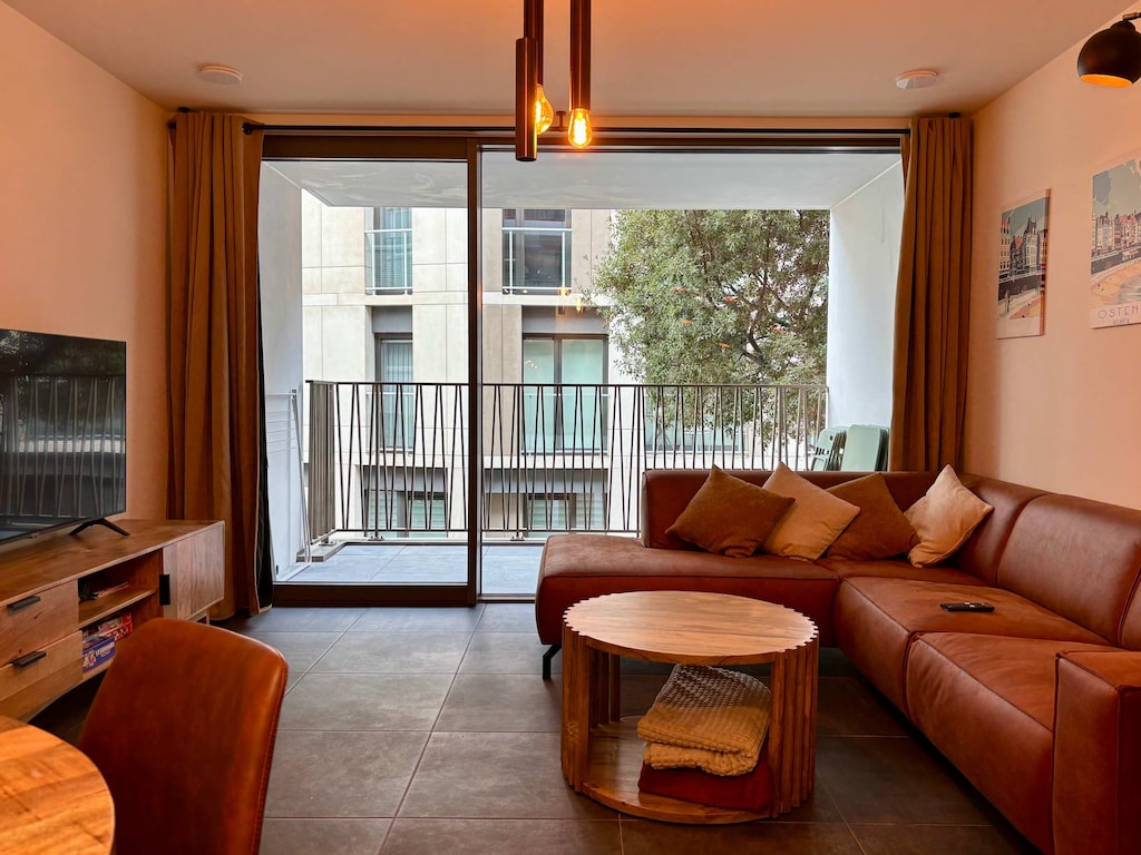 Bright living room with floor-to-ceiling windows, perfect for slow mornings ☀️