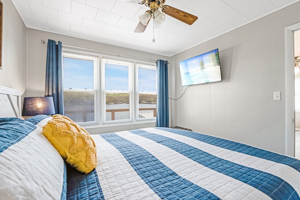 Contemporary and sleek bedroom design with a wall of windows showcasing the stunning lake view.
