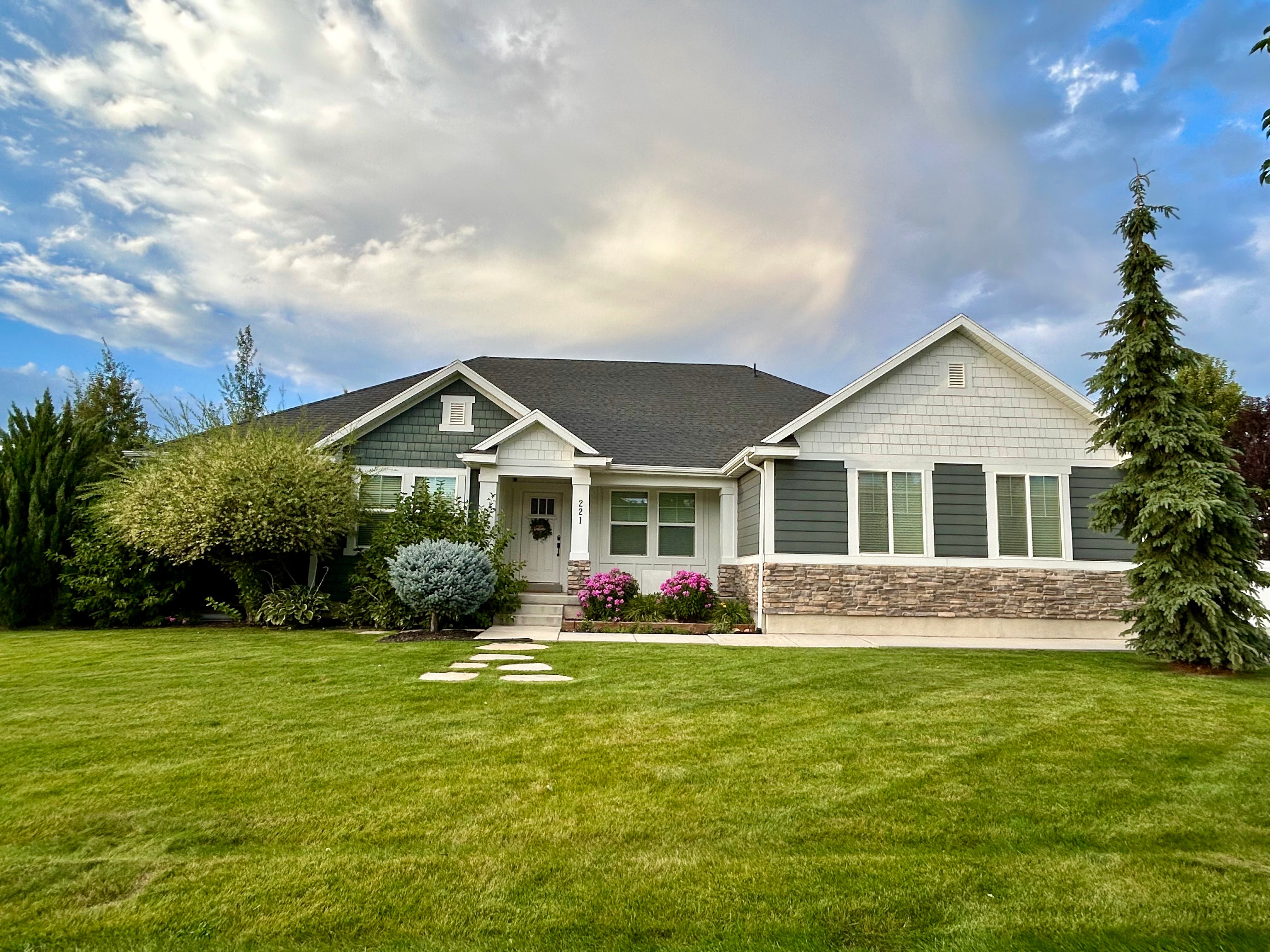 The large grassy mature landscaped front yard of Huckleberry Lane.  Parking on the street for trailers during spring, summer and fall months.