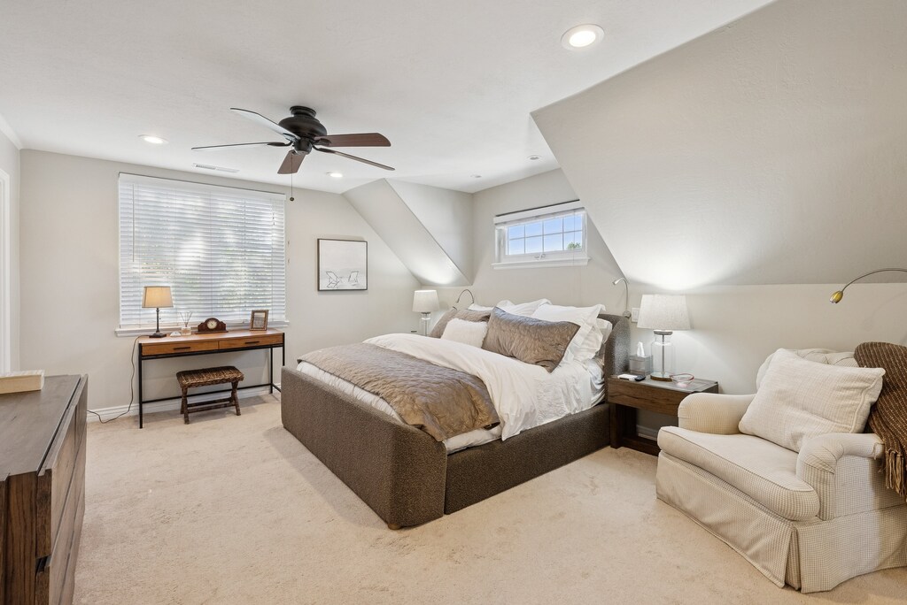 Stylish & roomy primary suite is light & bright.  Adjustable pillow-top plush king.  Quality linens, down duvets/pillows, Reading chair, dedicated work space, 65" flat screen TV.  Private en-suite bath w/soaking tub & hand held sprayer.  Nice closet.