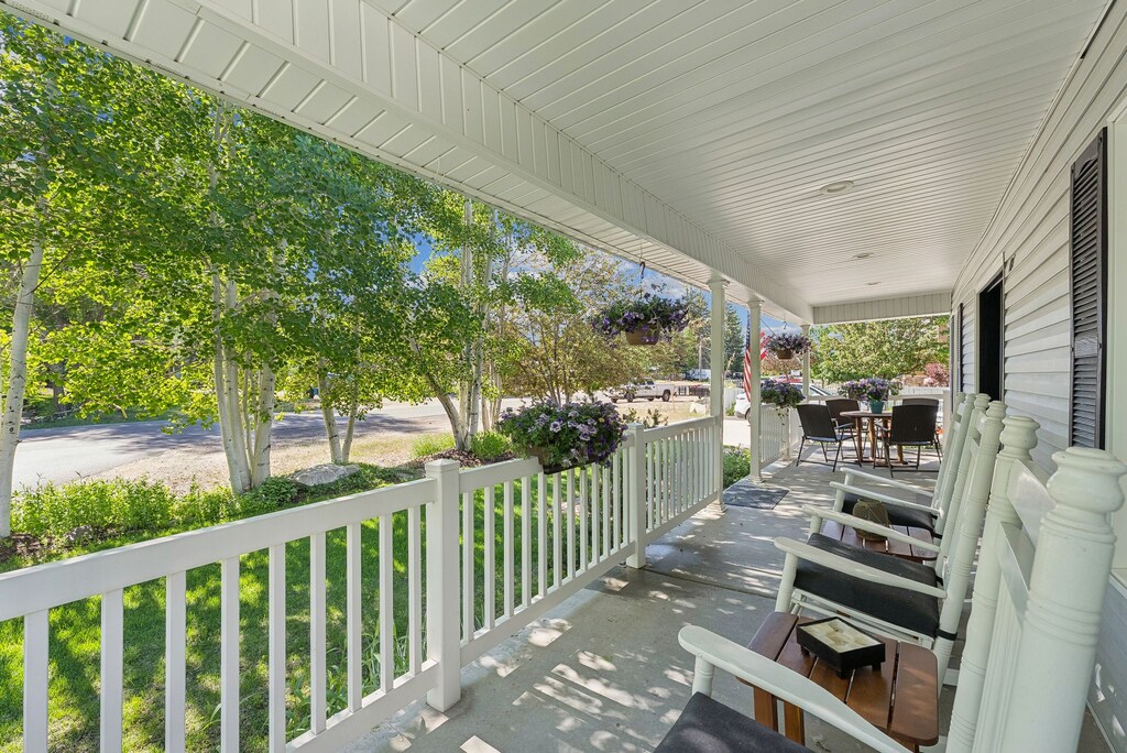Large East facing covered front porch with outdoor dining and 3 comfy rocking chairs.  Perfect for morning coffee or relaxing on a warm summer afternoon in the shade.