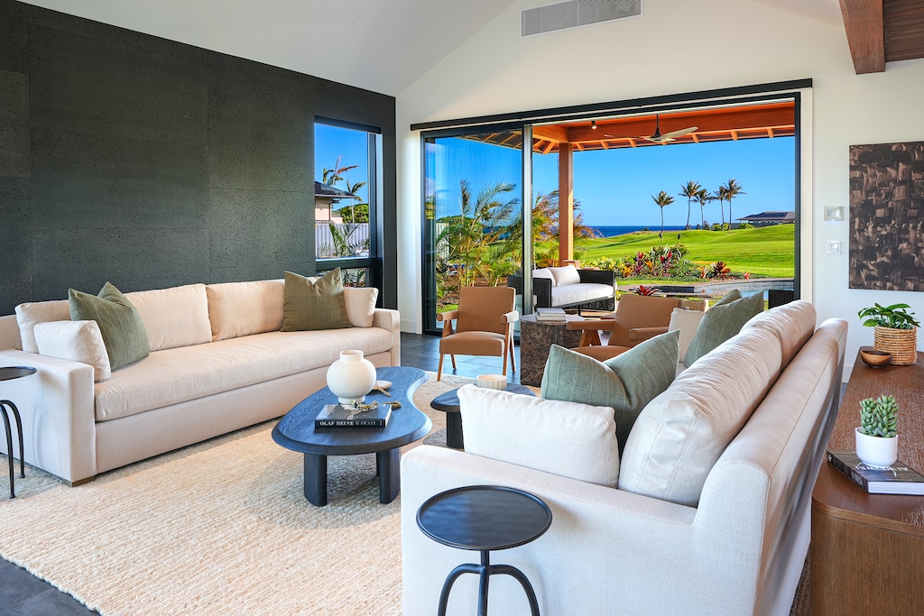 Main living room with retractable glass walls and soft natural light.
