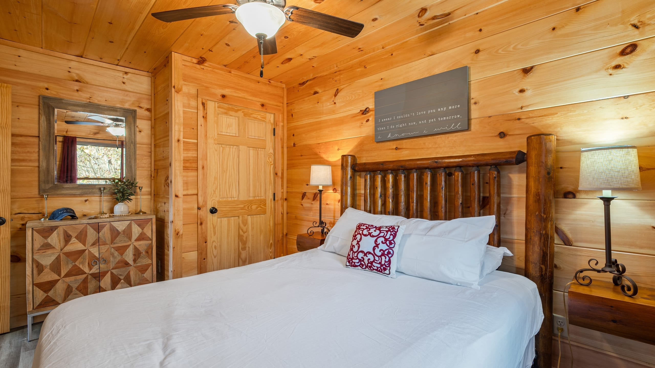 The bedroom features a queen bed and a TV.