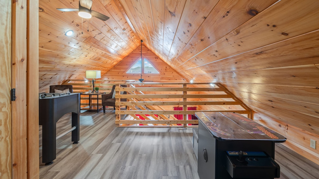 Cozy loft game room featuring foosball and a classic Pac-Man arcade.