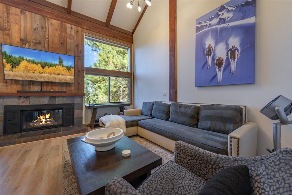 Spacious and inviting: This large sofa offers ample seating for the whole party, making it the perfect spot to gather around the cozy fireplace and take in the stunning Tahoe forest views through the windows.
