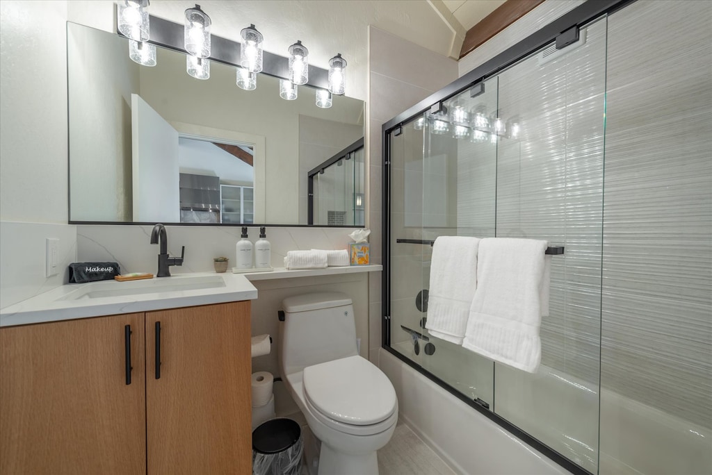 Step into this well-lit upstairs bathroom, complete with modern fixtures, a glass door shower tub and complimentary toiletries for your stay.