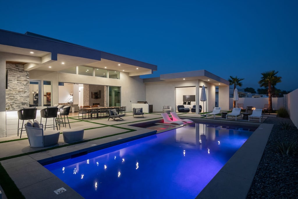 Experience the luxury of a desert evening! The illuminated pool, hot tub, outdoor dining area, and wet bar create a spectacular private resort setting.
