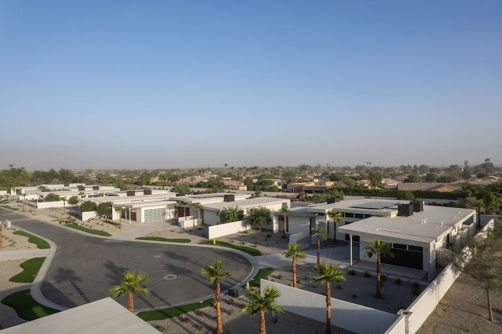 Expansive aerial views of the stunning modern home and neighborhood, perfectly set against the backdrop of the Coachella Valley mountains.