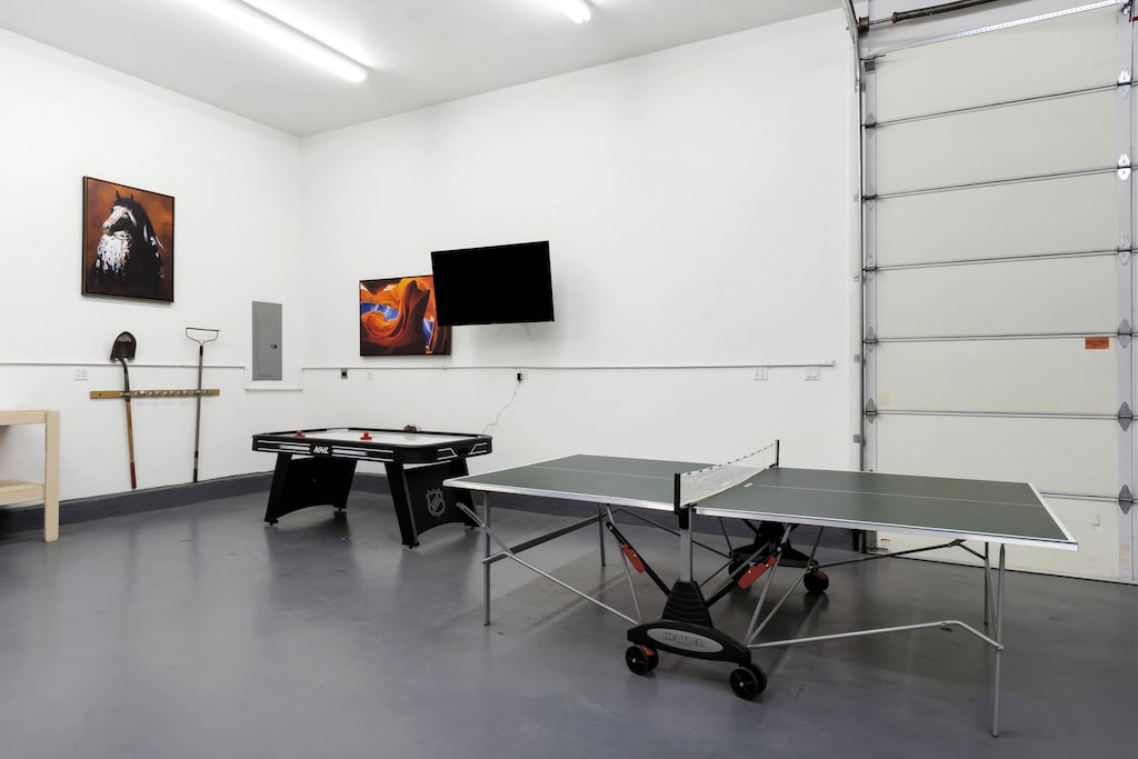 Garage game room with air hockey and ping pong table