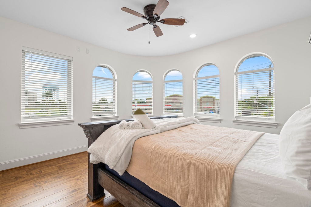 Big beautiful windows allow plenty of natural light in this bedroom.