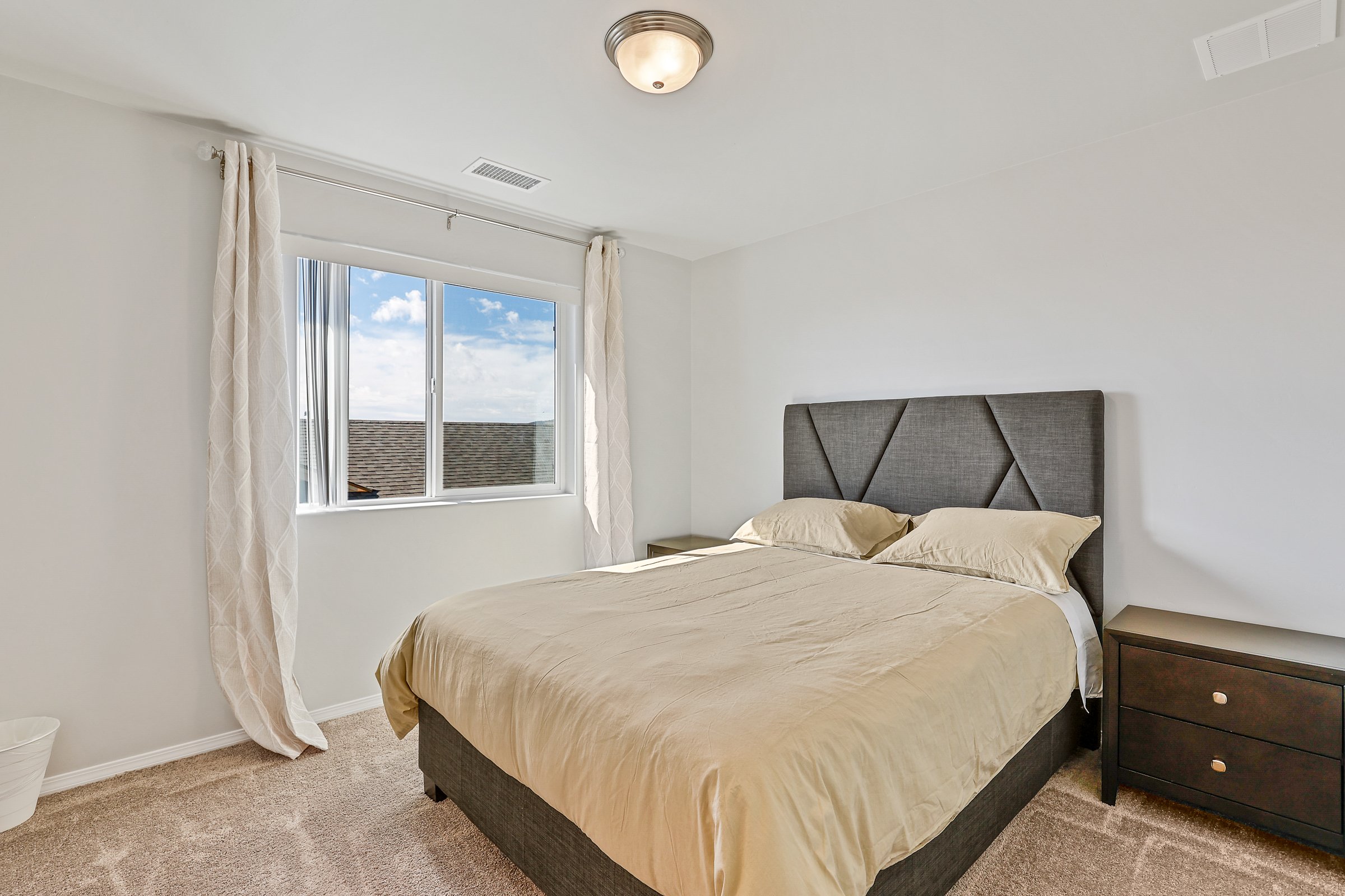 Second Primary Suite: Queen-sized bed and private en-suite bathroom.