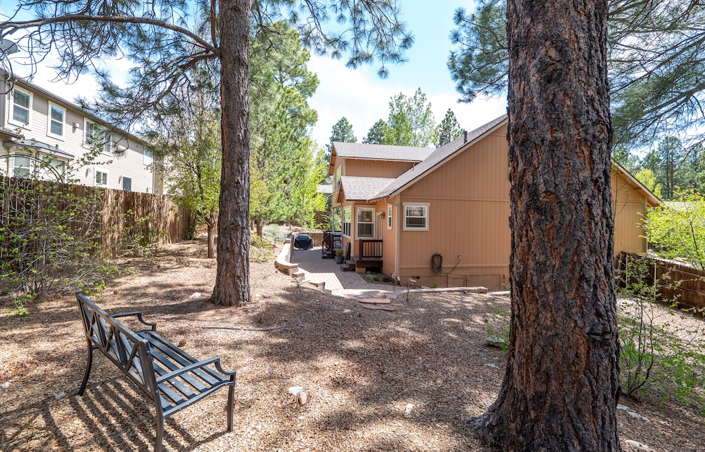 Outdoor Paradise – Fenced backyard with a cozy deck seating and BBQ grill, plus charming front porch.