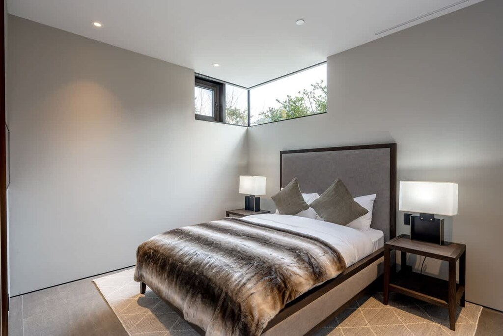 - Inviting bedroom with plush bedding and cozy textures  
- Minimalist design enhanced by natural light and calm tones  
- Perfect for relaxation after outdoor adventures  