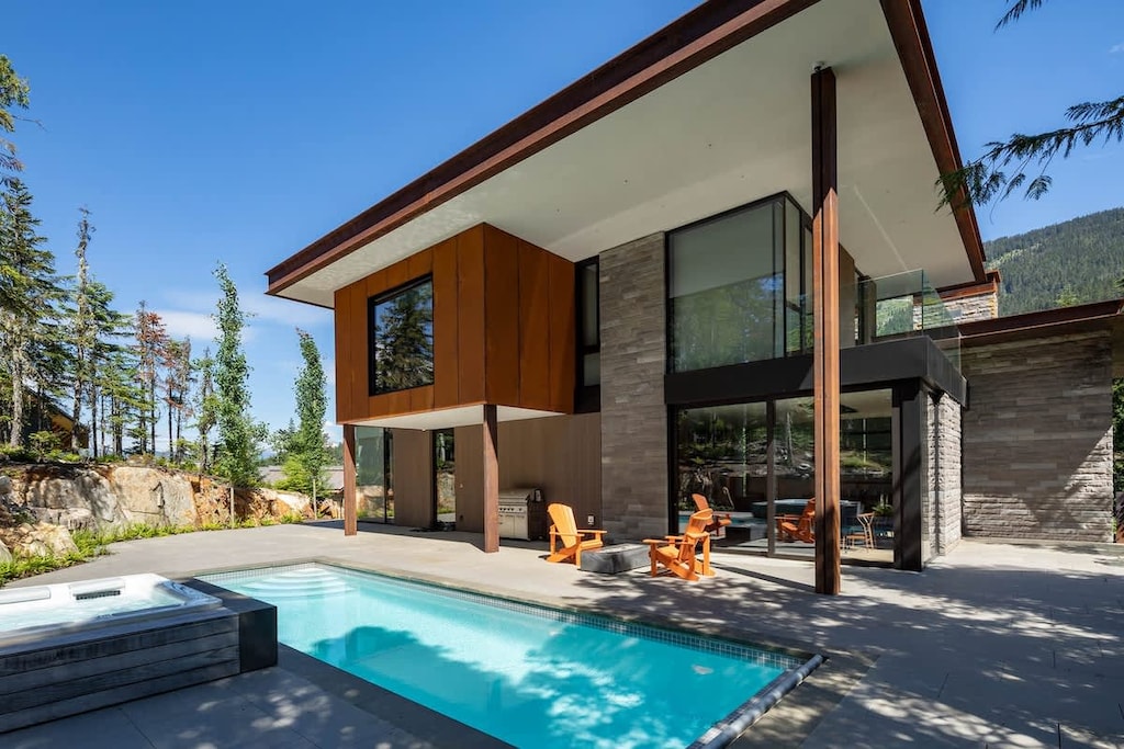 - Stunning modern exterior with pool and mountain backdrop  
- Outdoor seating for gathering after a refreshing swim  
- Designed for year-round comfort and scenic relaxation  
