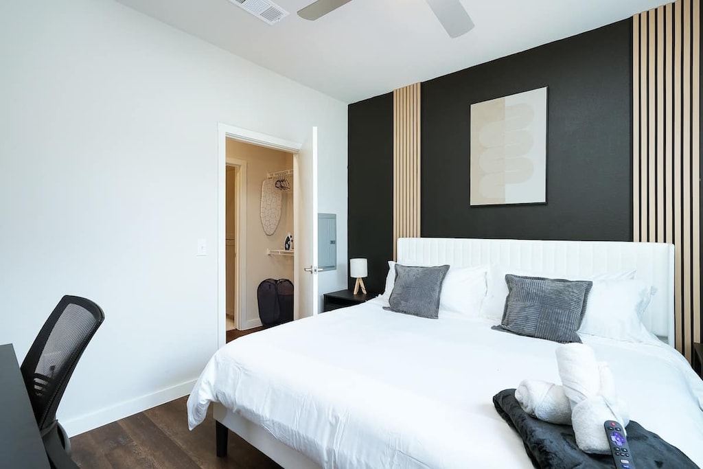 Experience the perfect retreat in our bedroom, featuring a king-sized bed, TV, and a green touch from the indoor plant.