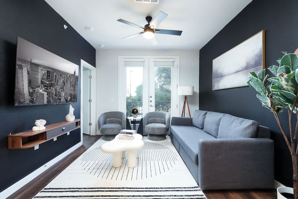 Our living room is the perfect retreat, with comfy seating, a large window, and artistic touches that add personality.