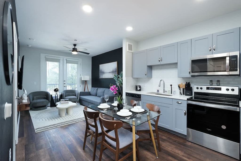 Relax and enjoy meals in a serene dining room, complete with a white orchid centerpiece and circular mirror.