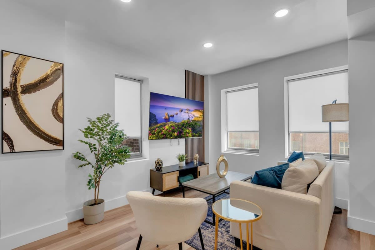 Bright, open living space featuring a TV.