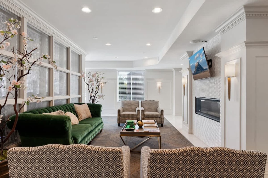 Relax in our cozy living room, surrounded by lush tree plants and comfortable seating.