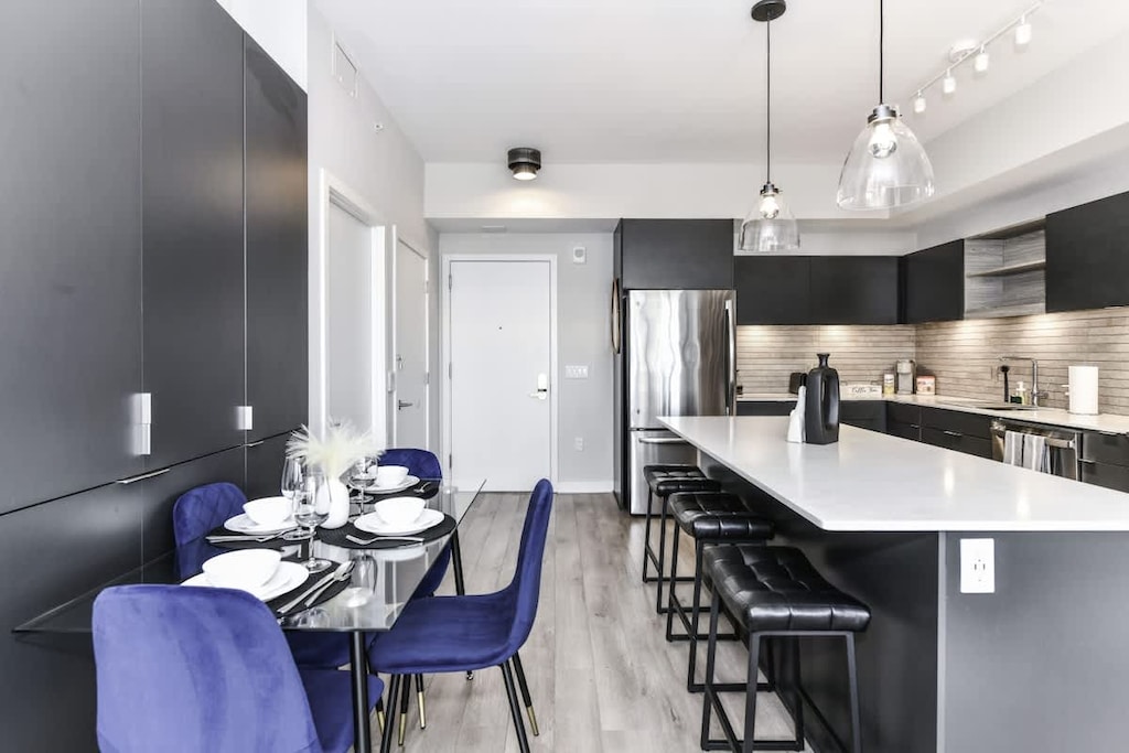 Fully equipped kitchen with a breakfast counter (seats 3) and a dining area (seats 4), plus a high chair available for little ones.