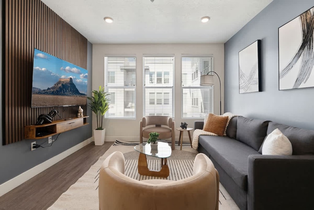 Natural light and cozy vibes – our living room features a TV and beautiful, large windows.