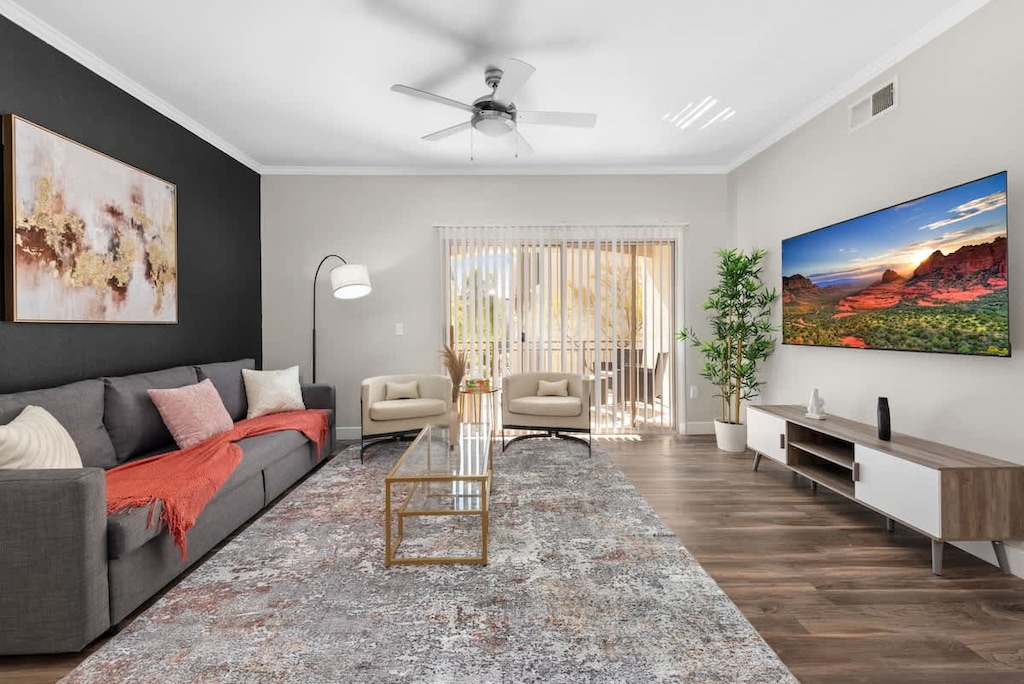Living area with sofa, chairs, table and TV