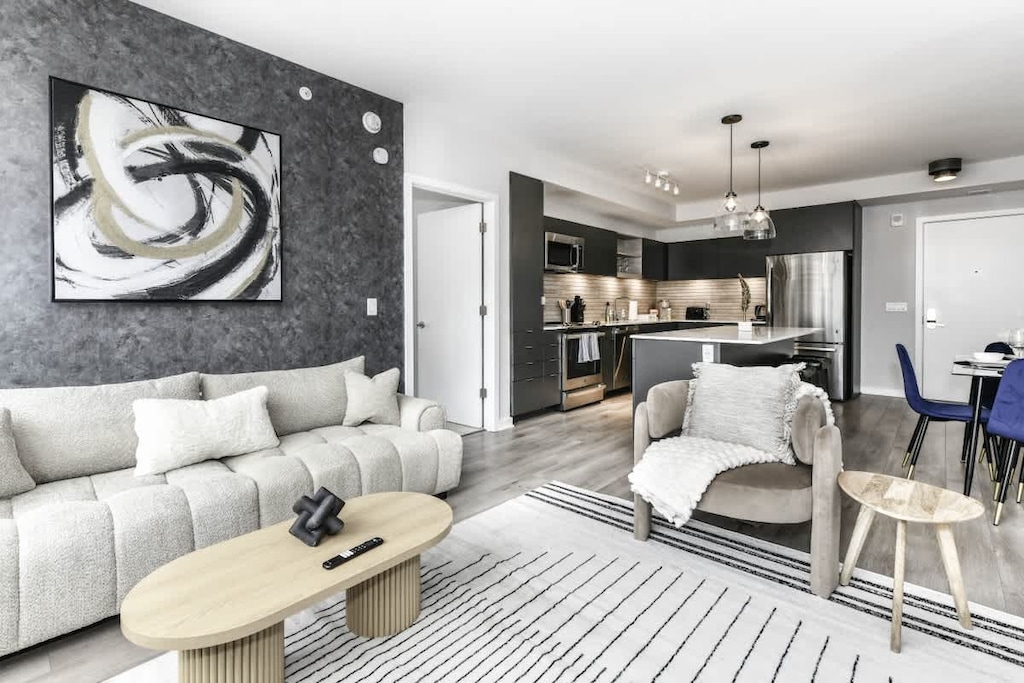 Chic and bright living room with cozy couch, flatscreen Tv and dedicated work station