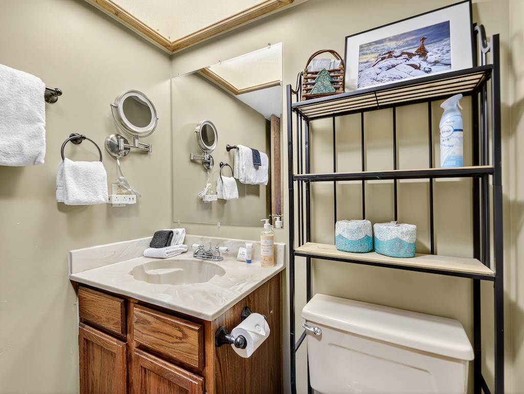 Your private bathroom features thoughtful touches like magnifying mirrors for getting ready, fluffy towels, and convenient storage shelving to keep your essentials organized during your stay.