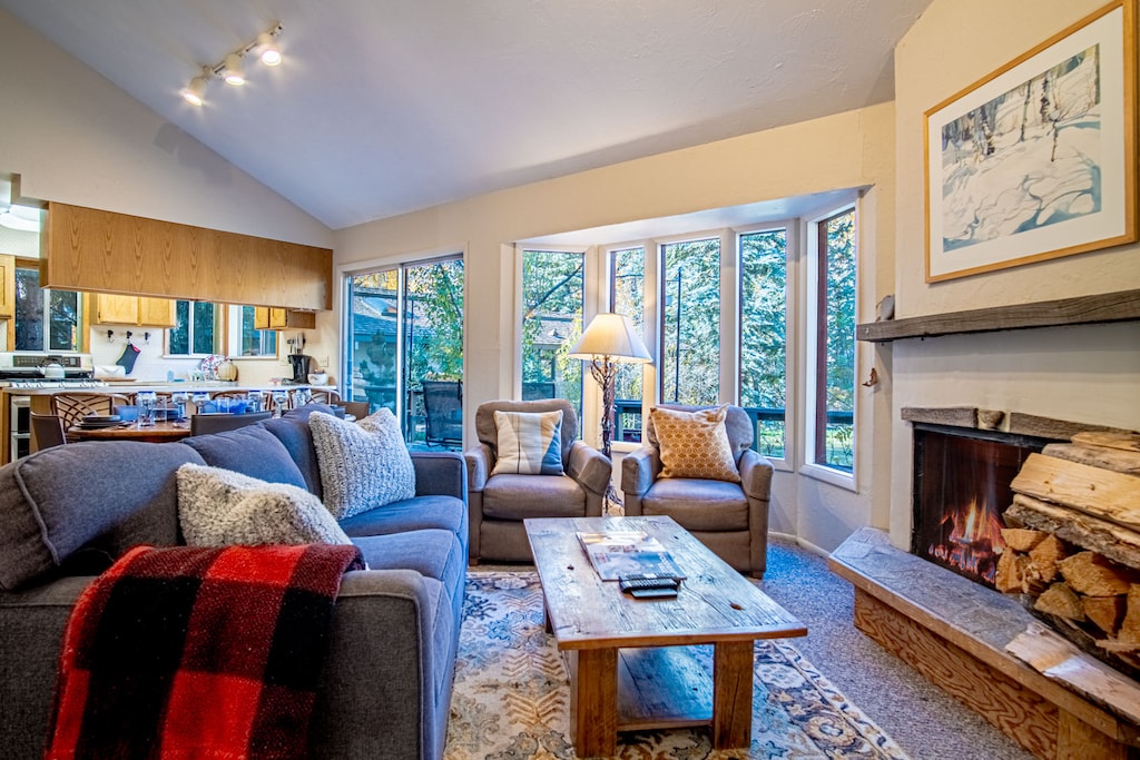 Cozy open living area with wood-burning fireplace