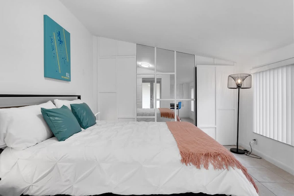 “Spacious bedroom with natural light, chic décor, and plenty of storage—ideal for your vacation rental comfort.”