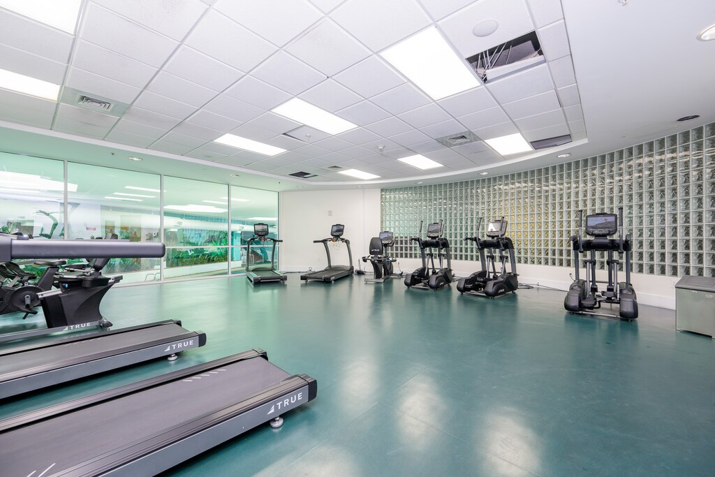 Stay active in the fitness center featuring modern equipment and a refreshing view of the bay through large windows